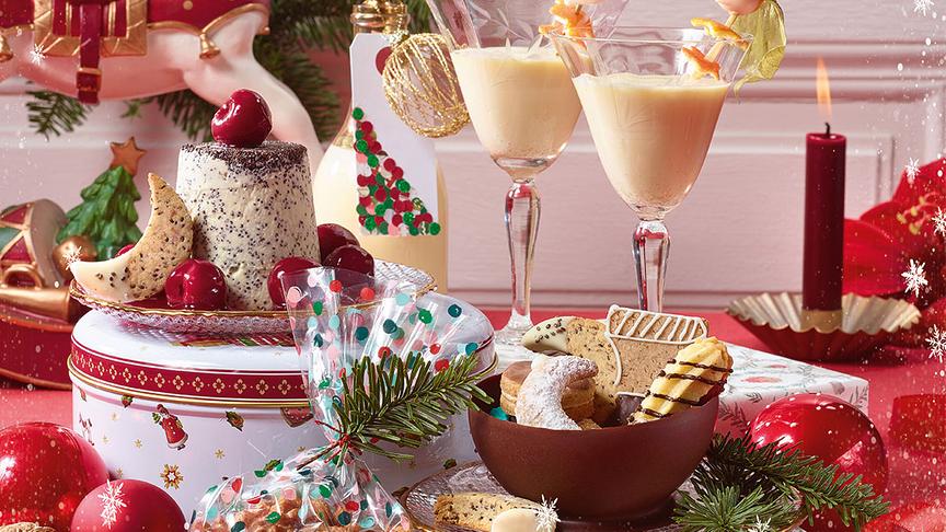 Festlich gestaltete Titelseite mit Weihnachtsleckereien, Getränken und Geschenkideen und dem Text „Ihr Wegbegleiter für die Festtage – 40 Ideen für dren Dezember“.