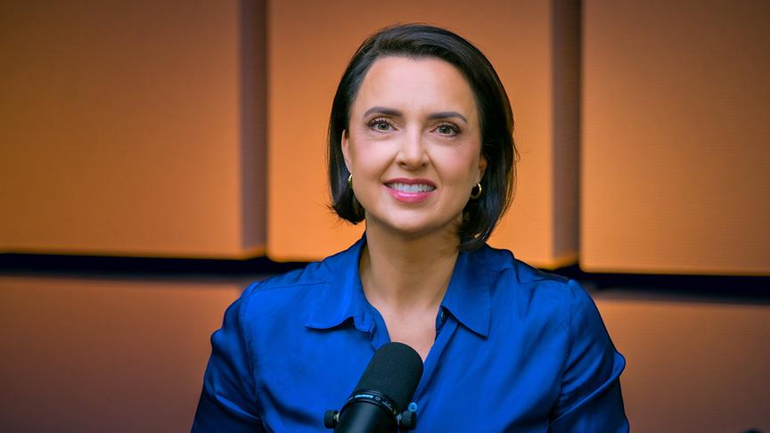 Susanne Schnabl vor einem Mikro im Studio zu  (Video-)Podcast „Das Gespräch Schnabl &"