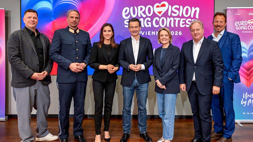 Gruppenfoto mit Oliver Lingens, Landespolizeivizepräsident General Dieter Csefan, Alexandra Maritza Wachter, ORF-Generaldirektor Roland Weißmann, ORF-Programmdirektorin Stefanie Groiss-Horowitz,  ORF-Direktor für Technik und Digitalisierung Harald Kräuter und Michael Krön vor "Eurovision Song Contest"-Wand