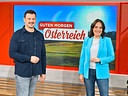 Sigi Fink und Eva Pölzl stehen im Studio von „Guten Morgen Österreich“ vor einem großen Bildschirm.